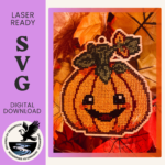 Image of a festive pumpkin template in wood and completed with cross stitch embroidery