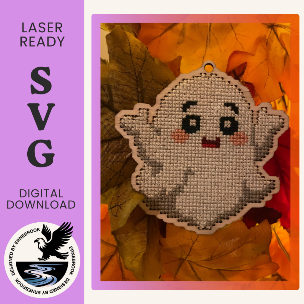 A white, friendly ghost cross-stitch home decoration. Cut out of 3mm plywood with a cross-stitch design embroidered on, and resting on Autumn coloured leaves.