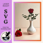 Image of a single red rose template in wood and completed with cross stitch embroidery in a white vase. A real red rose is laying to the side.