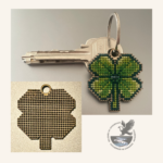 A photo of the wooden 4 leaf clover lucky key fob template next to a completed cross-stitch project